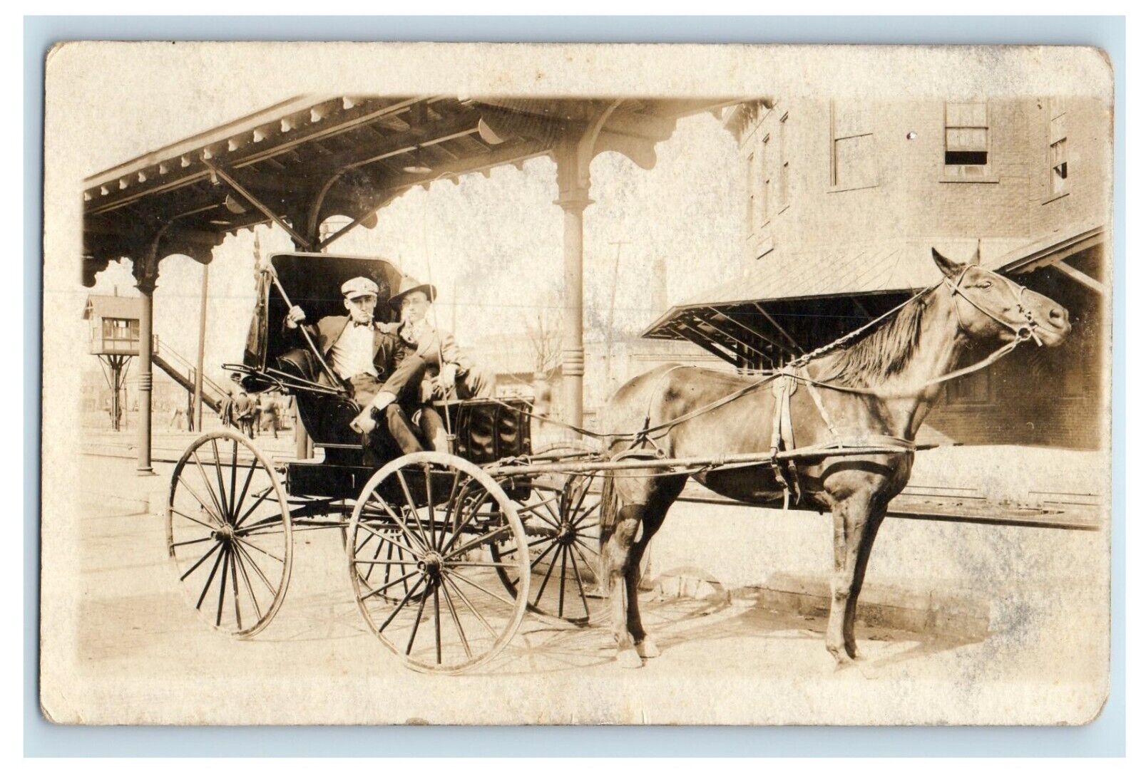 c1910 Two Men Horse Buggy Overhead Railroad Track Station RPPC Photo Postcard
