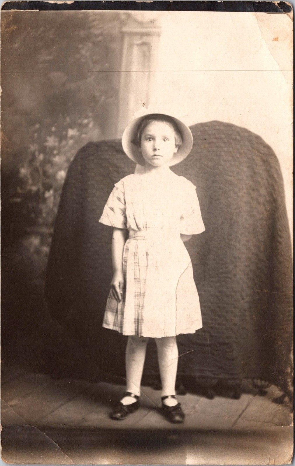 Postcard RPPC Unknown Startled Child Girl Hat Blanket Covers Object c1910