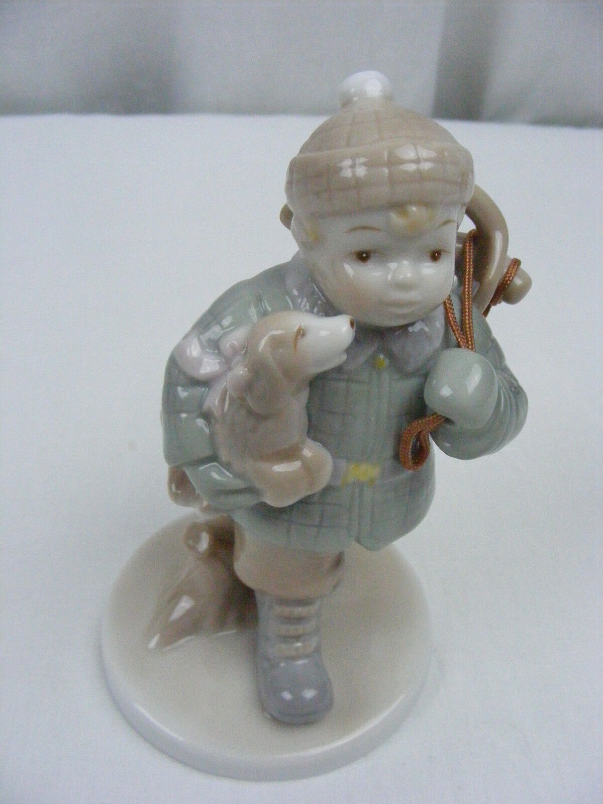Vintage Marbella Collection Porcelain Figurine Boy with Sled Holding Puppy