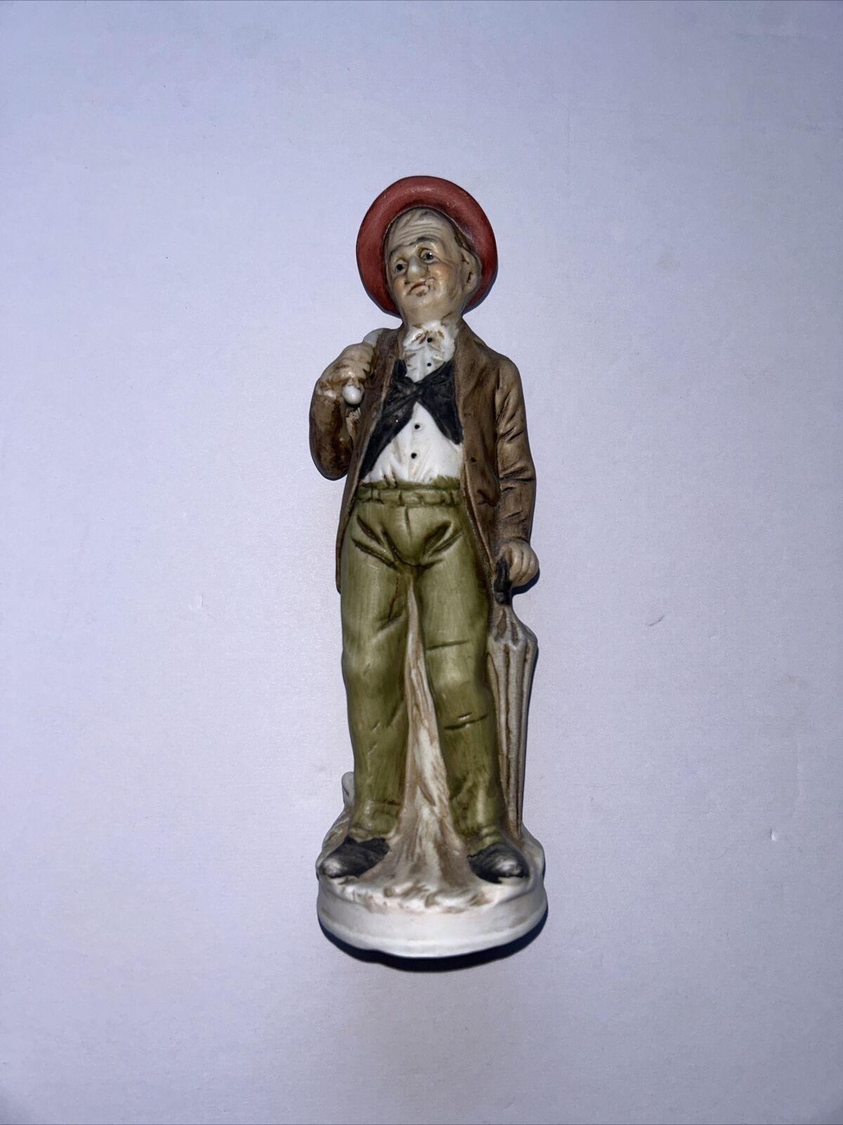 Vintage ceramic ornament/figurine. Old man With Umbrella And Red Hat
