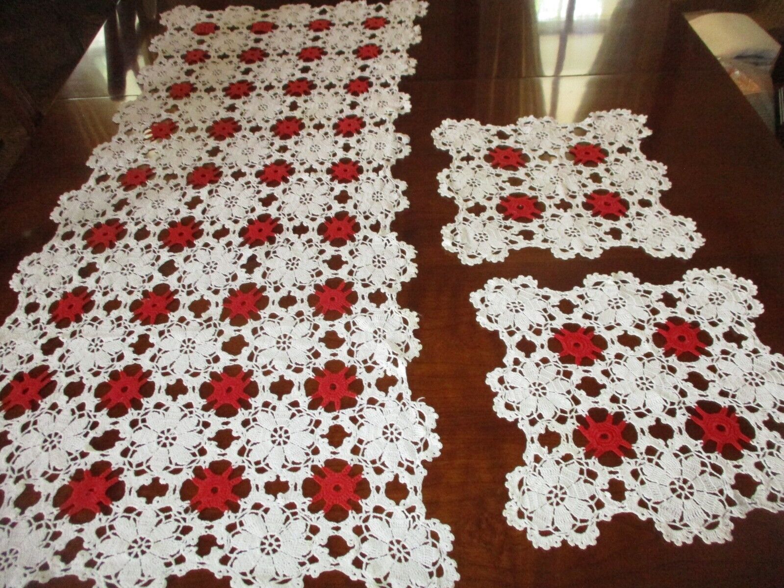 Vintage crocheted wt/red table runner and 2 match. doilies