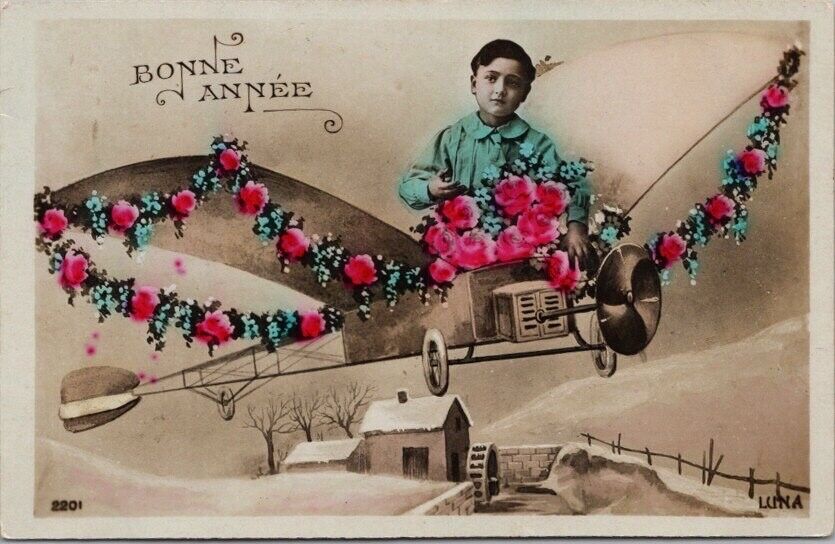 c1910s French BONNE ANNEE New Year Tinted Photo RPPC Postcard Boy in Airplane