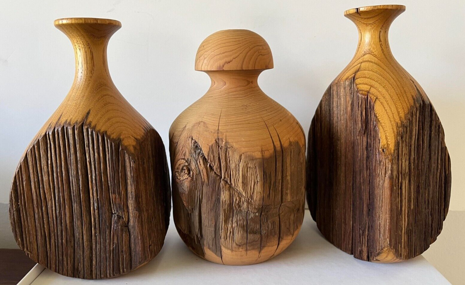 Three vintage midcentury hand-carved wooden bud vases.