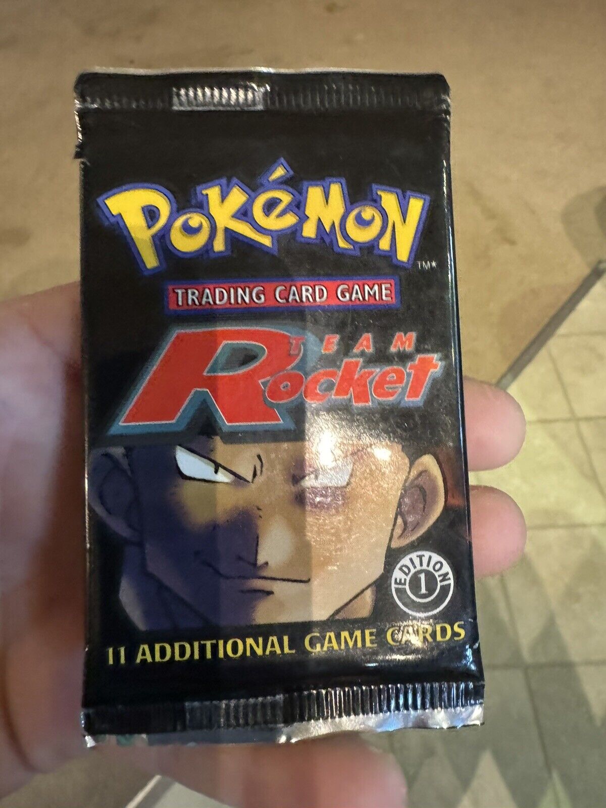 One unopened, factory sealed pack of Pokémon Team Rocket Edition 1 1 card pack