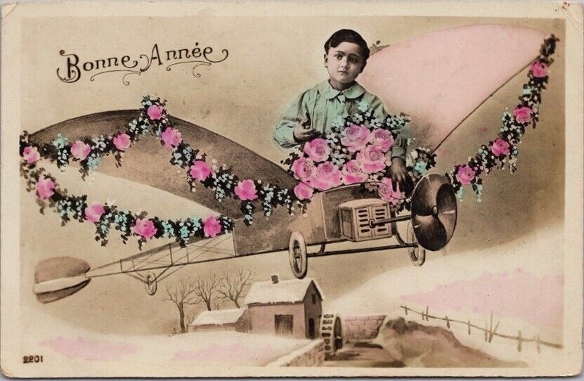 c1910s French BONNE ANNEE Tinted Photo RPPC Postcard Boy in Airplane / Roses