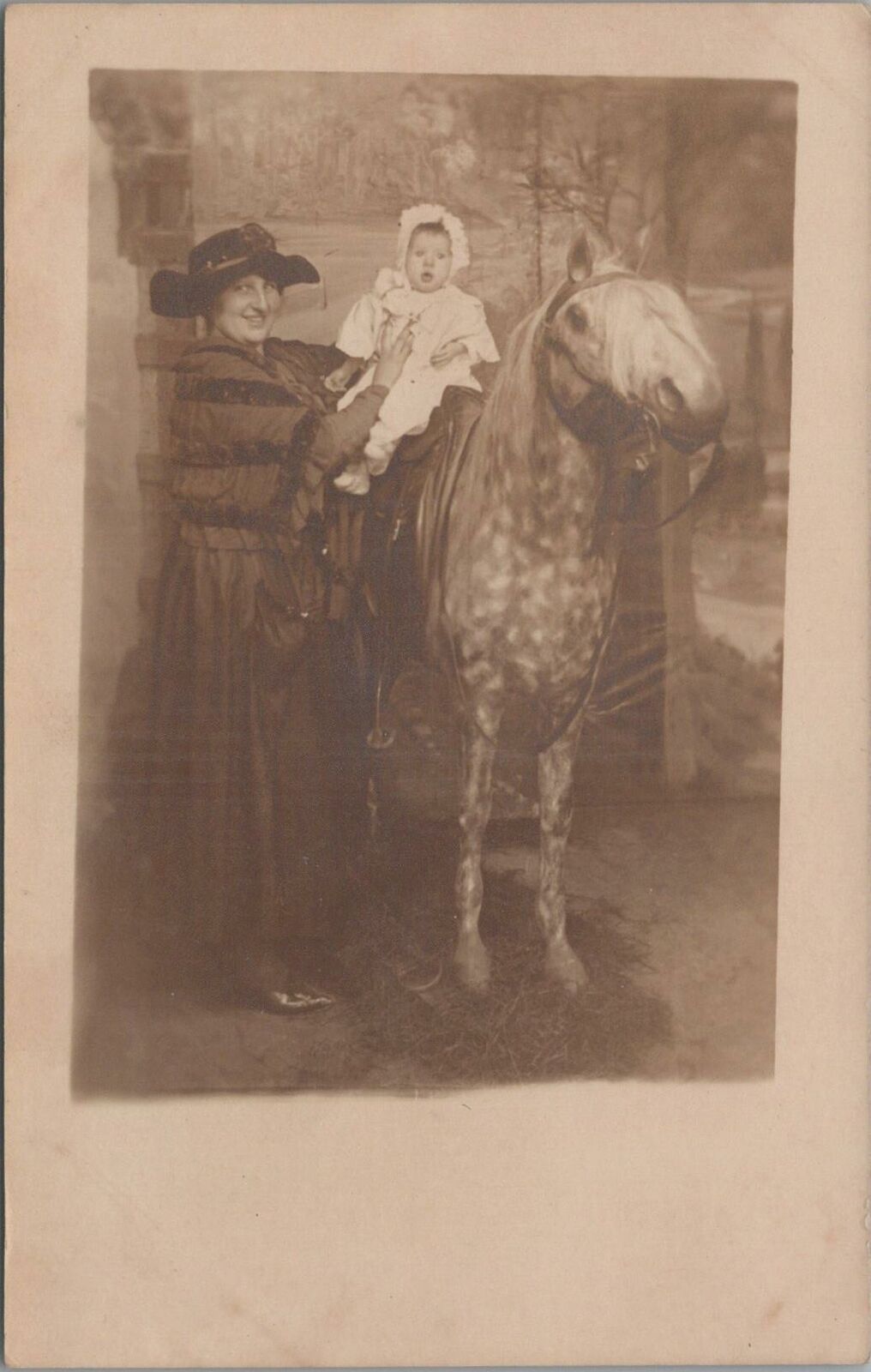 RPPC Postcard Woman Putting Baby on Spotted Horse 