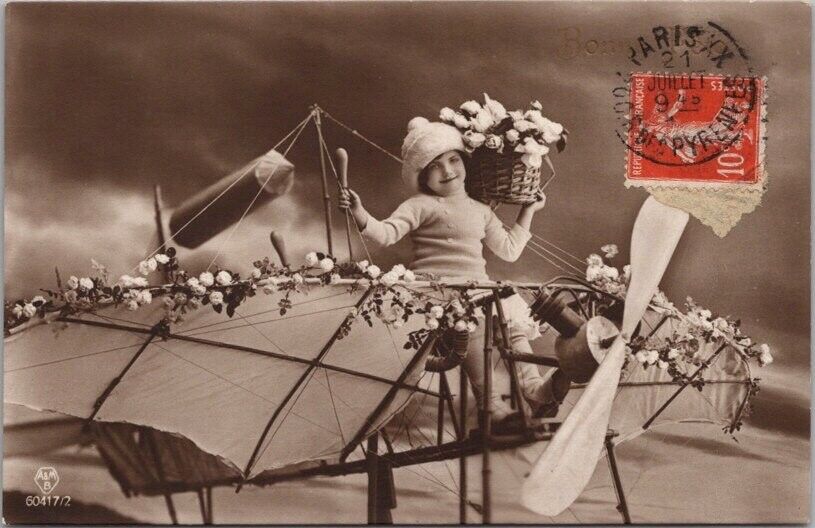 c1910s French Fantasy Tinted Photo RPPC Postcard Girl / Airplane / Flowers