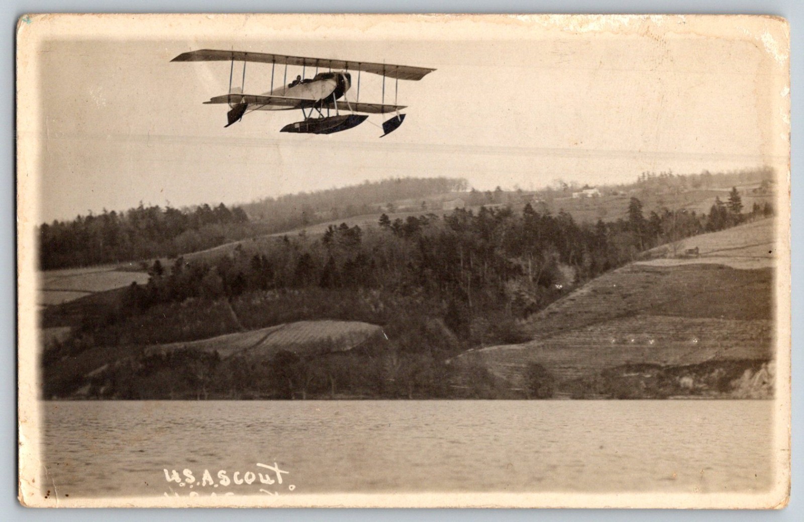 Vintage RPPC WWI Biplane USAS Scout Seaplane Flying Over River Military Aircraft