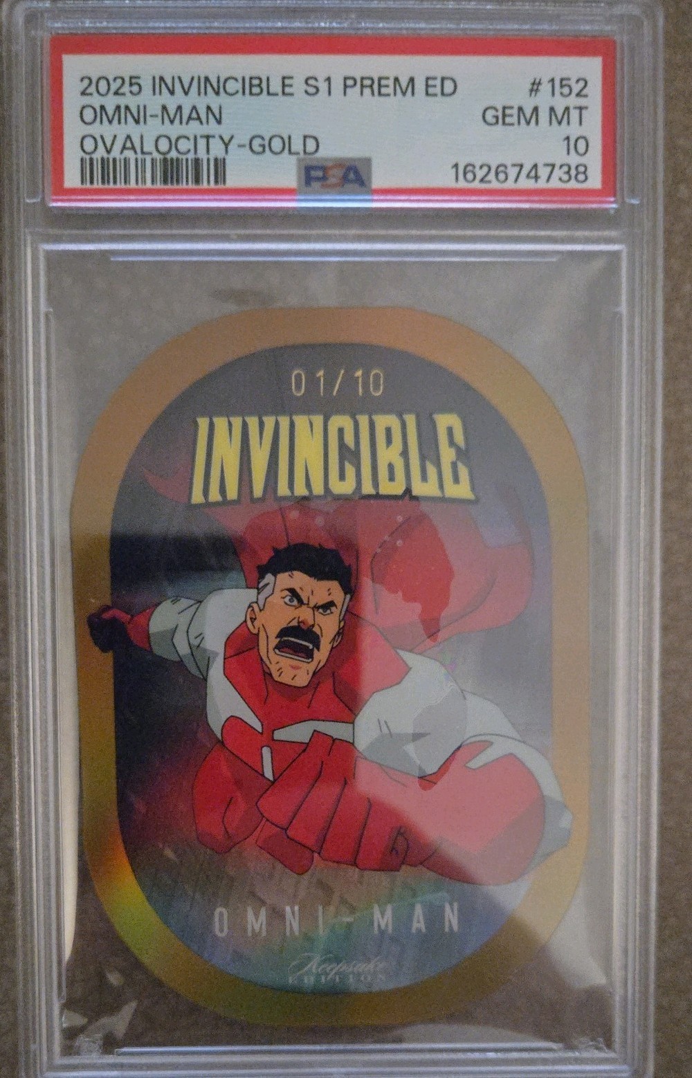 OMNI-MAN 2025 INVINCIBLE 1/10 OVALOCITY-GOLD PREM ED DIE-CUT PSA 10 KEEPSAKE OMNI-MAN 2025 INVINCIBLE 1/10 OVALOCITY-GOLD PREM ED DIE-CUT PSA 10 KEEPSAKE