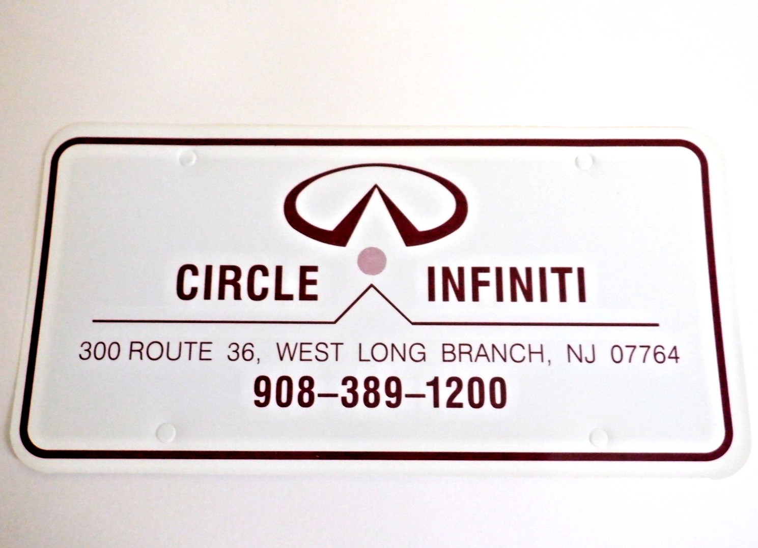 NOS 1990s Circle INFINITI WEST LONG BRANCH NJ Dealer LICENSE PLATE Nissan Datsun