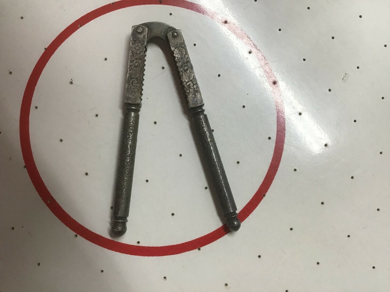 Antique tooled metal nut cracker