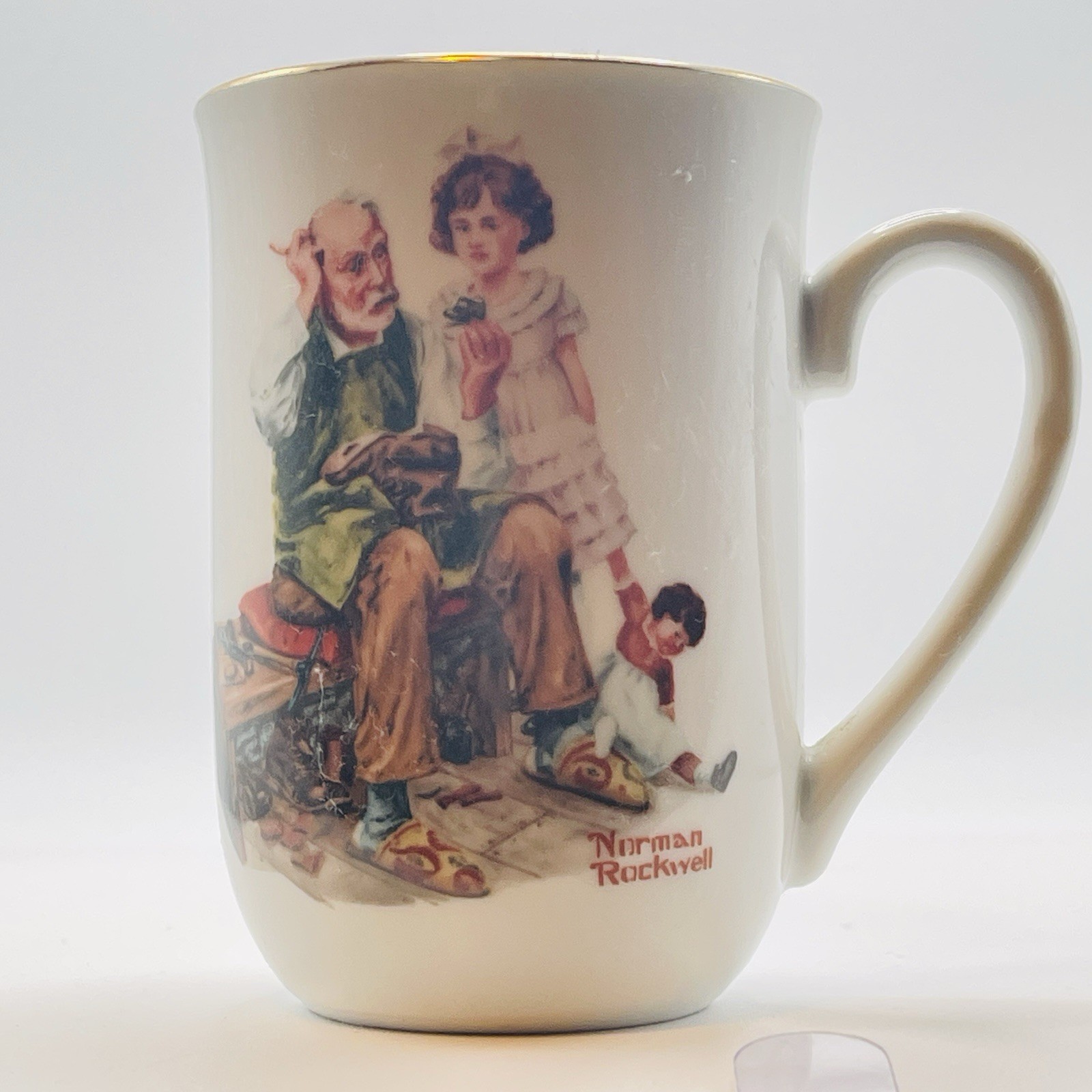 1982 VTG Norman Rockwell  “THE COBBLER” Porcelain Gold Rimmed Coffee/Tea Mug 4”
