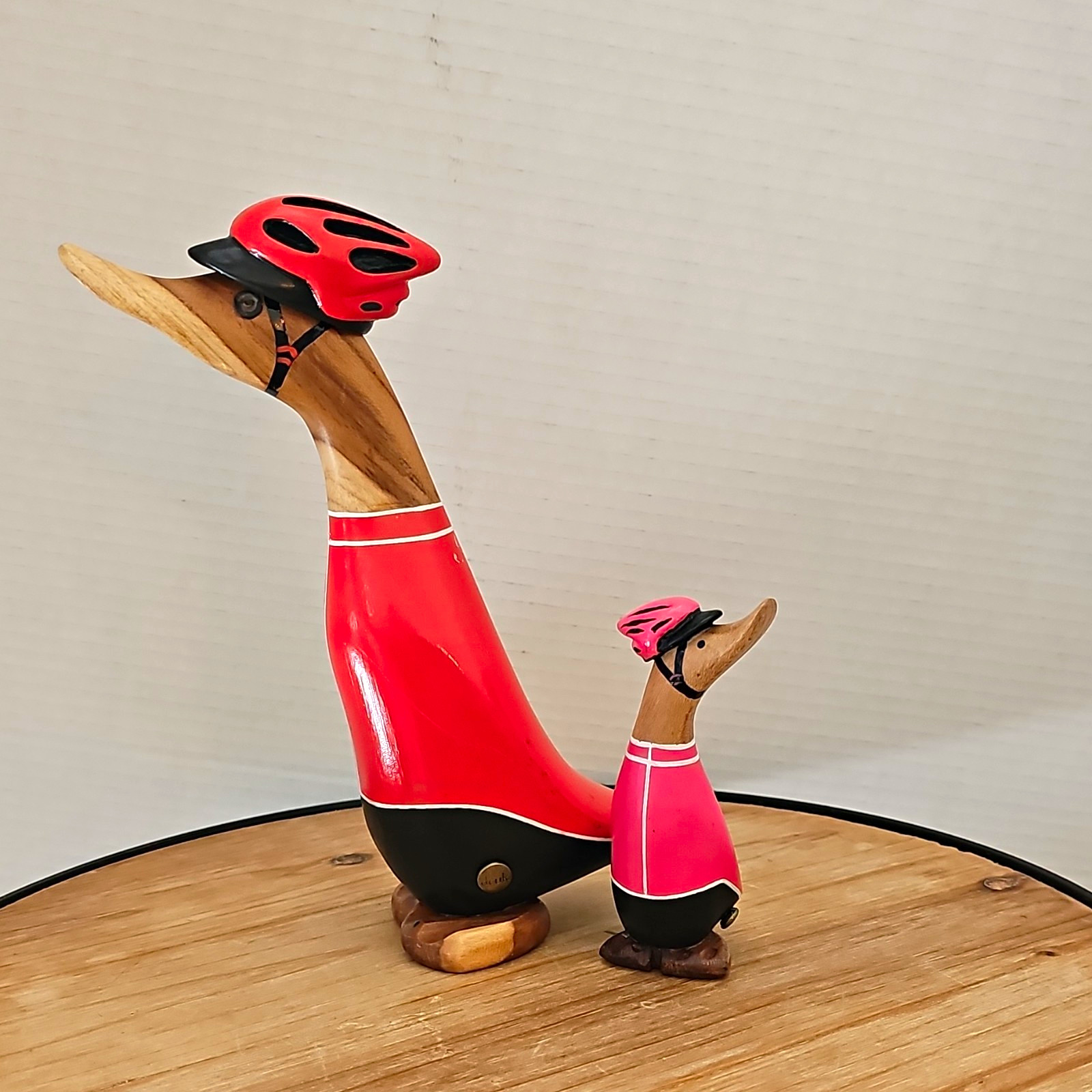 Dcuk cyclist Wood Duck Figurines wearing Helmets in Red & Pink Outfits
