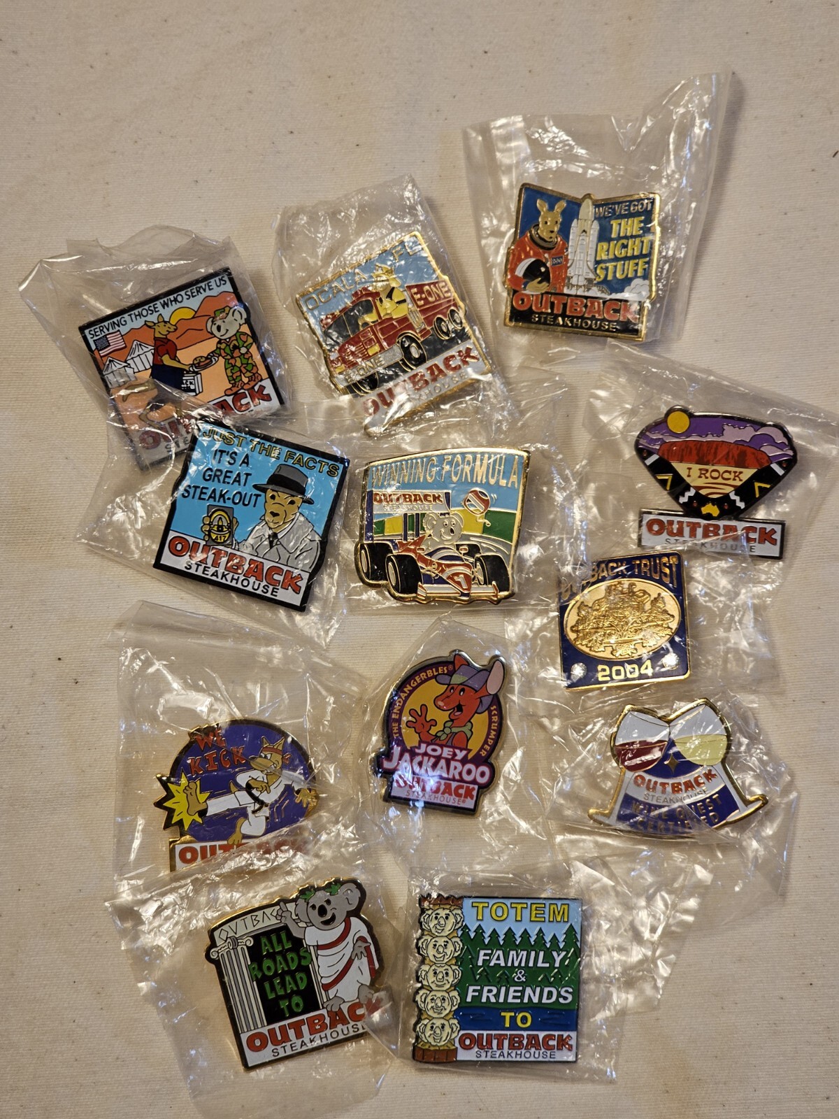 Outback Steakhouse Pins 12p Lot NEW Army PD Fire Florida Race Car Toga Koala  