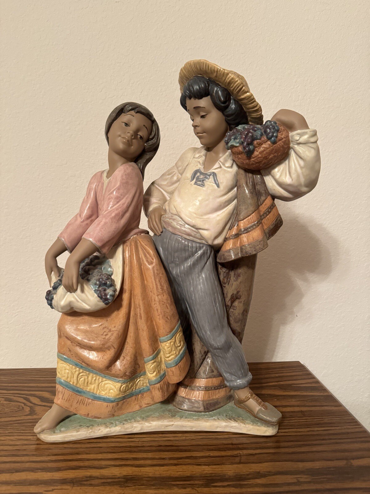 Lladro 2359 - First Crush (18” H, 12” W, 5” D) Lladro 2359 - First Crush (18” H, 12” W, 5” D)