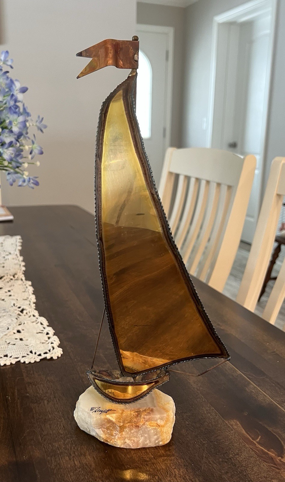 This is a signed mid-century John DeMott brass and copper sailboat sculpture.