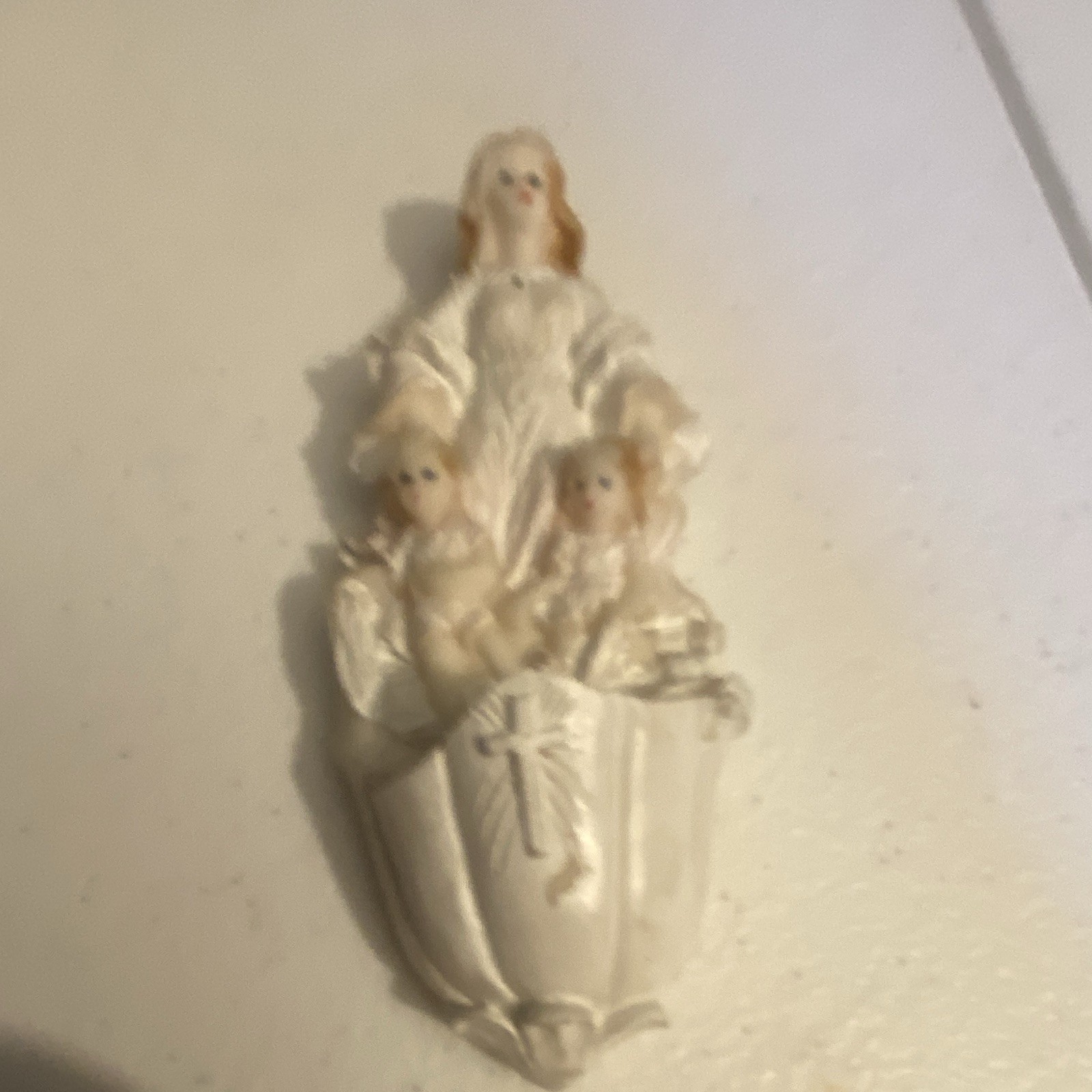 This item is a vintage guardian angel holy water font wall pocket.