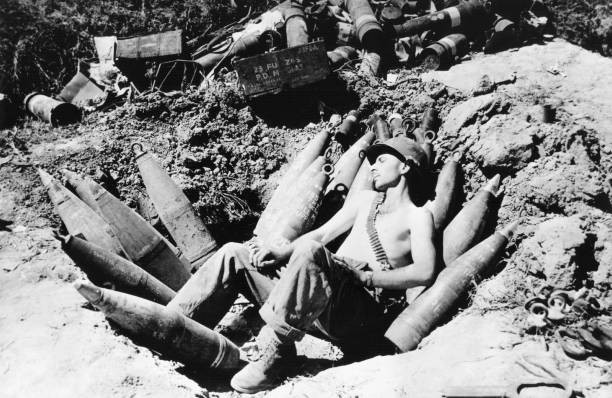 An American soldier sleeps on his ammunition in Mason area during - Old Photo