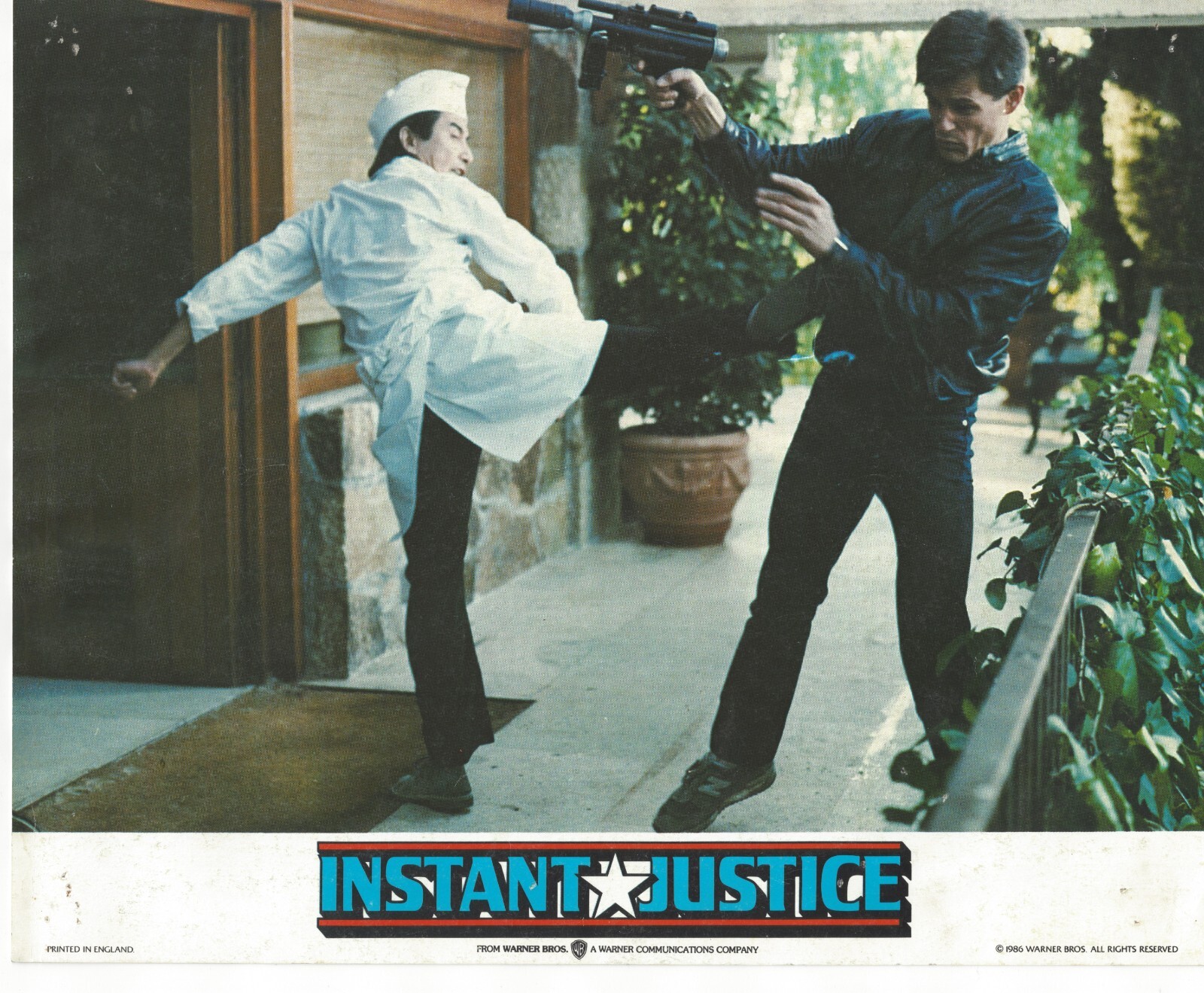 Instant Justice Michael Pare Press Photo 1986 UZI Gun Chef Karate Kick Revenge