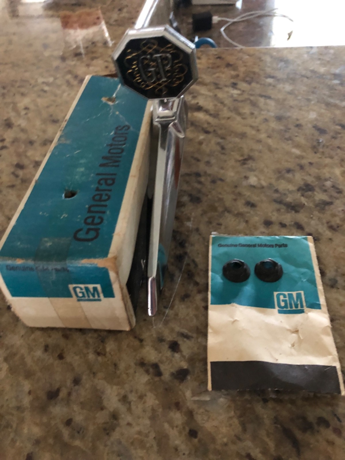 1975 Grand Prix NOS HOOD ORNAMENT AND BASE COMPLETE WITH HARDWARE 1975 Grand Prix NOS HOOD ORNAMENT AND BASE COMPLETE WITH HARDWARE