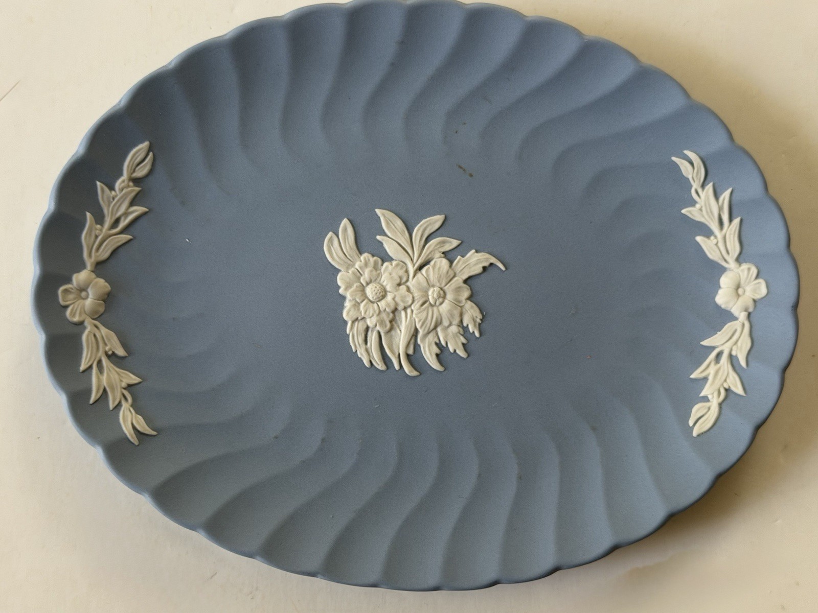 Small Wedgwood Jasperware plate, 7 X 5” oval, floral, matte blue, raised white