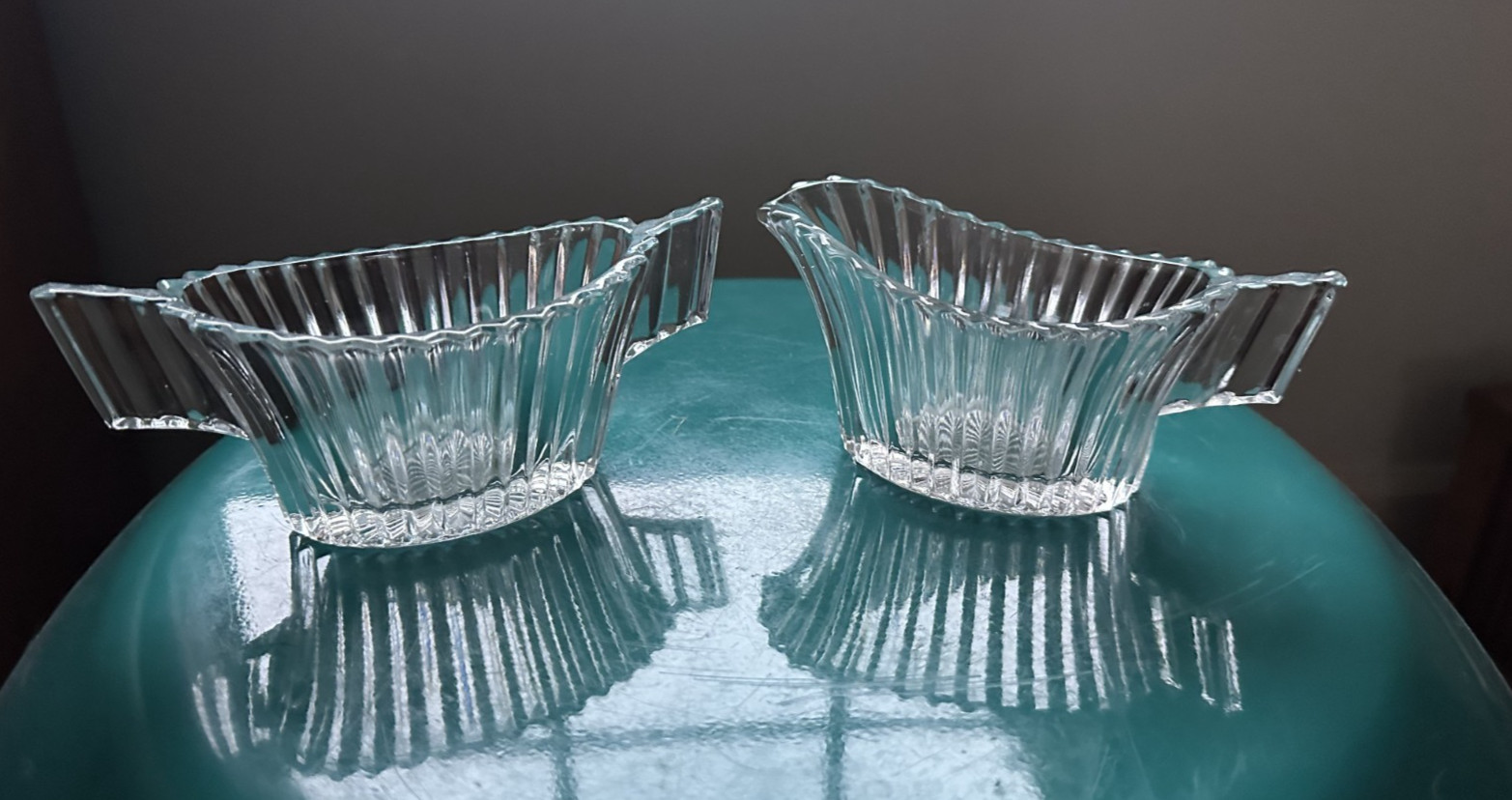 Art deco style creamer and sugar holders. Ribbed clear glass.