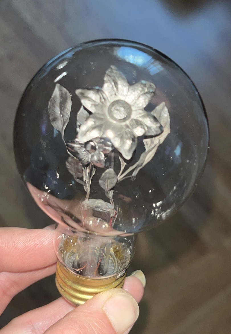1930's AEROLUX light bulb featuring a unique design with a floral bouquet