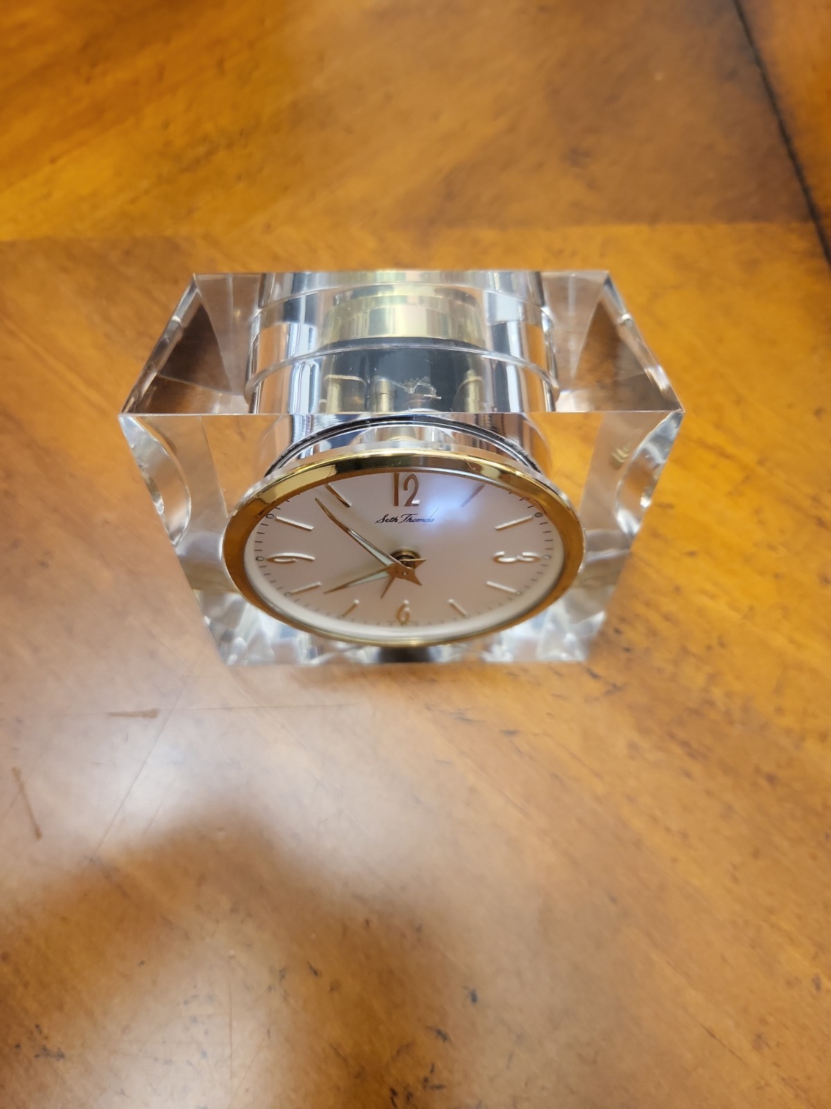 vintage Seth Thomas mechanical desk clock set into a thick lucite (acrylic)