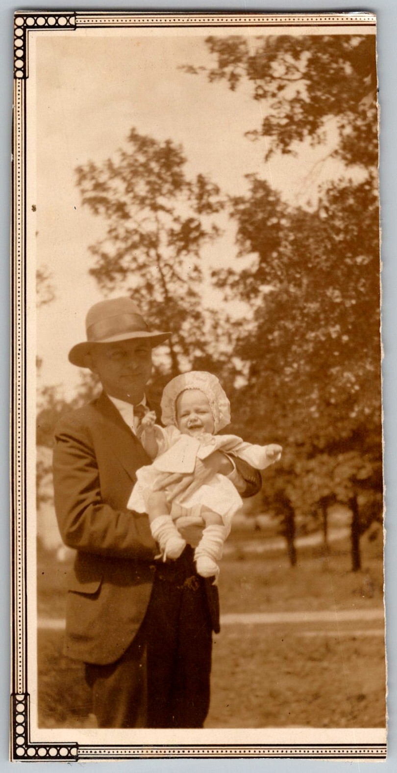 Vtg B&W Snapshot Man in Suit And Hat Holding Baby in Bonnet Outdoors 1920s