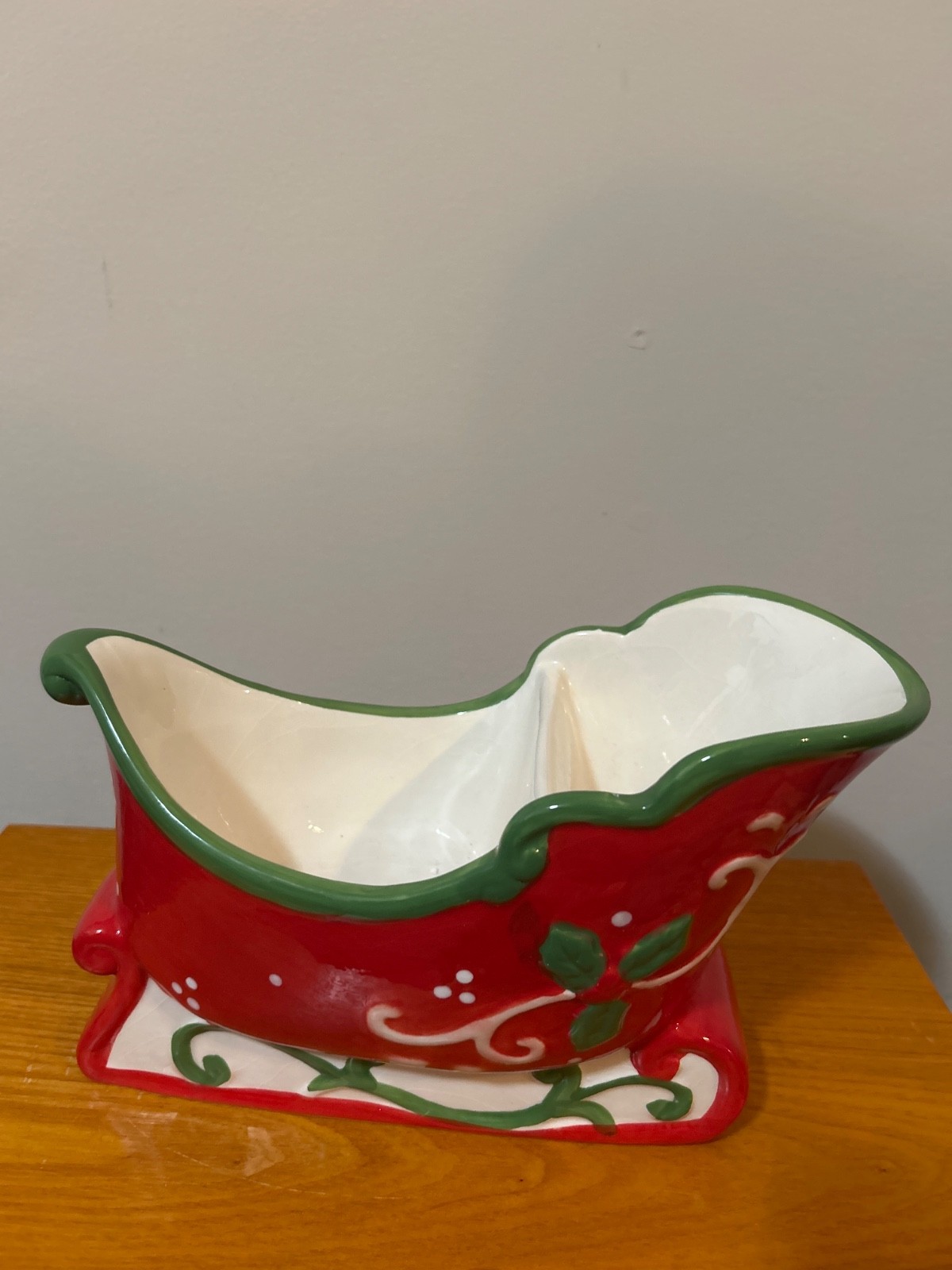 ceramic sleigh is a festive dish often used for candy or as a holiday centerpiec