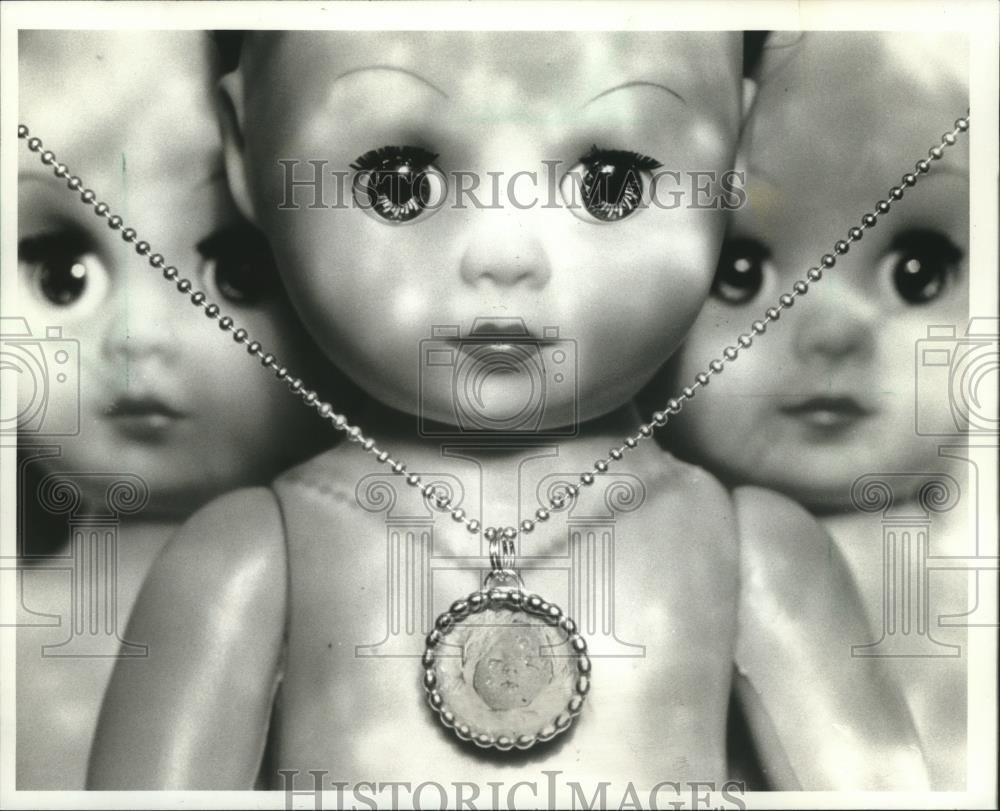 1994 Press Photo Trendy dead-baby necklace and dolls