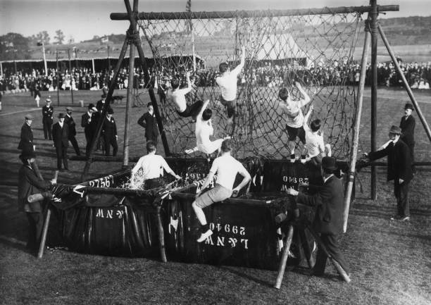 Competitors clambering over net during obstacle race London & Nort - 1913 Photo