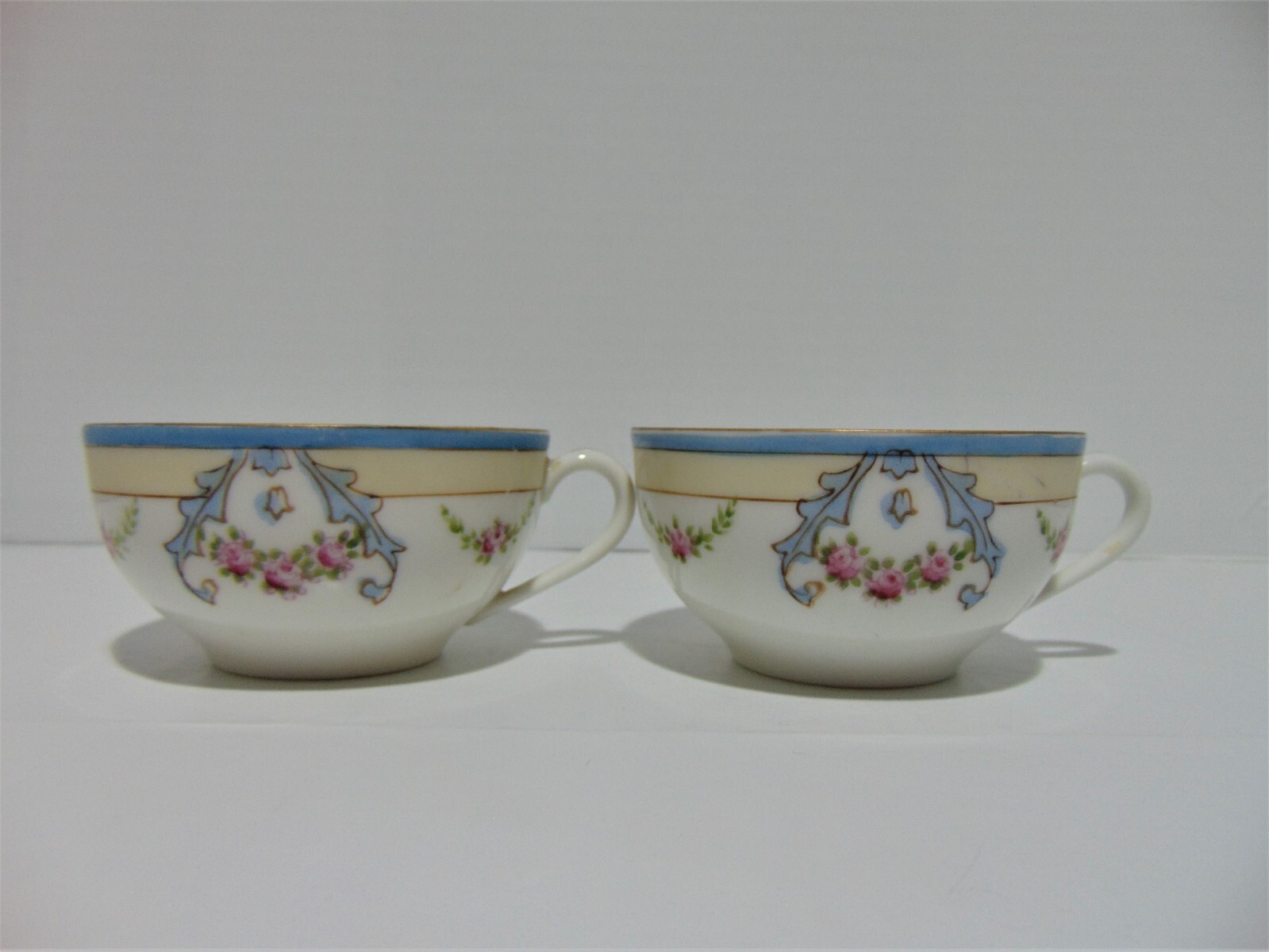 2 Noritake Hand Painted M Tea Cups 1925-1940 Blue Cream Rim Pink Roses Blue Swag 2 Noritake Hand Painted M Tea Cups 1925-1940 Blue Cream Rim Pink Roses Blue Swag