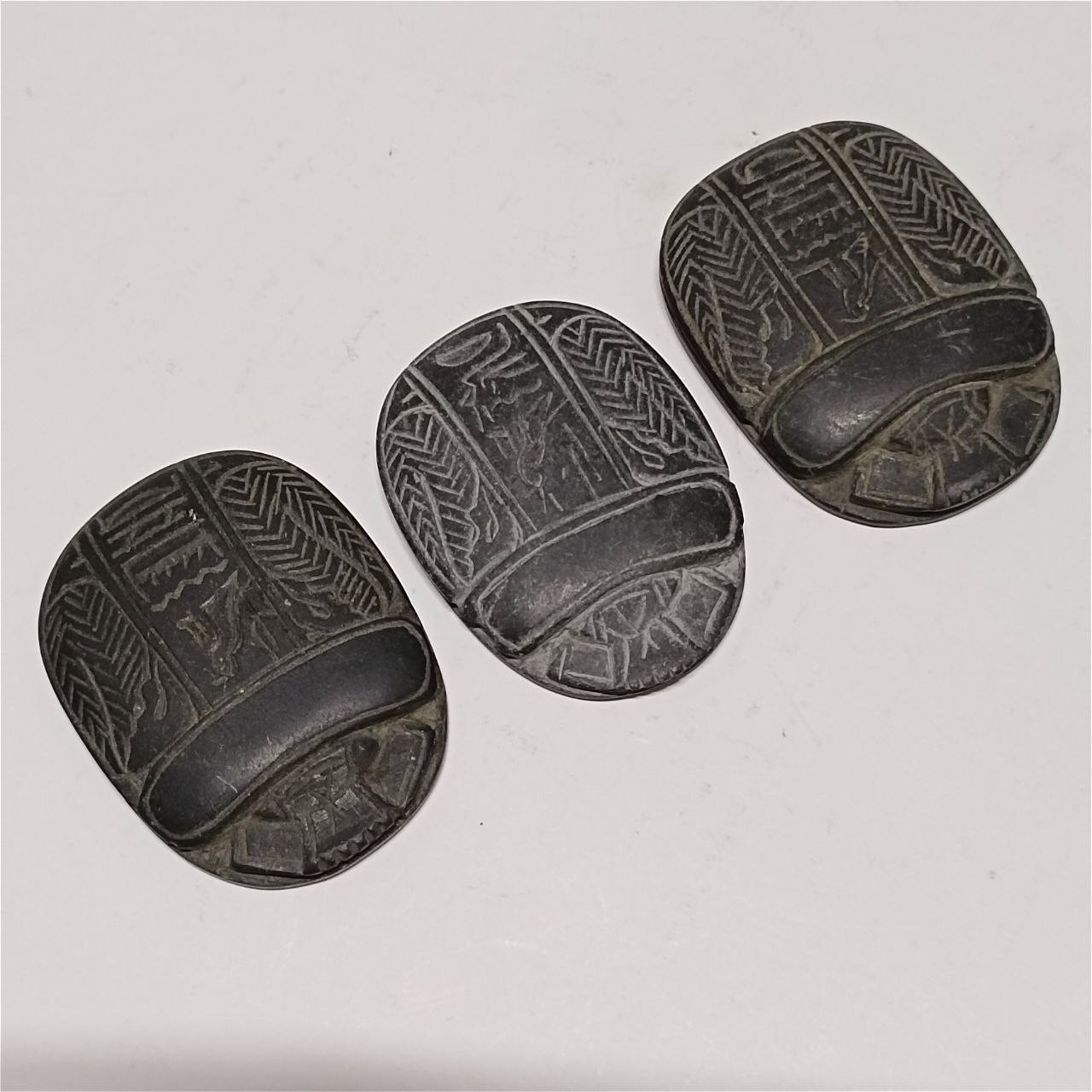 Ancient Egyptian inspired basalt scarab intricate carved hieroglyphic details Ancient Egyptian inspired basalt scarab intricate carved hieroglyphic details