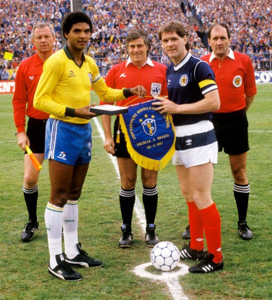 Brazil captain Geraldao exchanges pennants with opposite number Ro- Old Photo