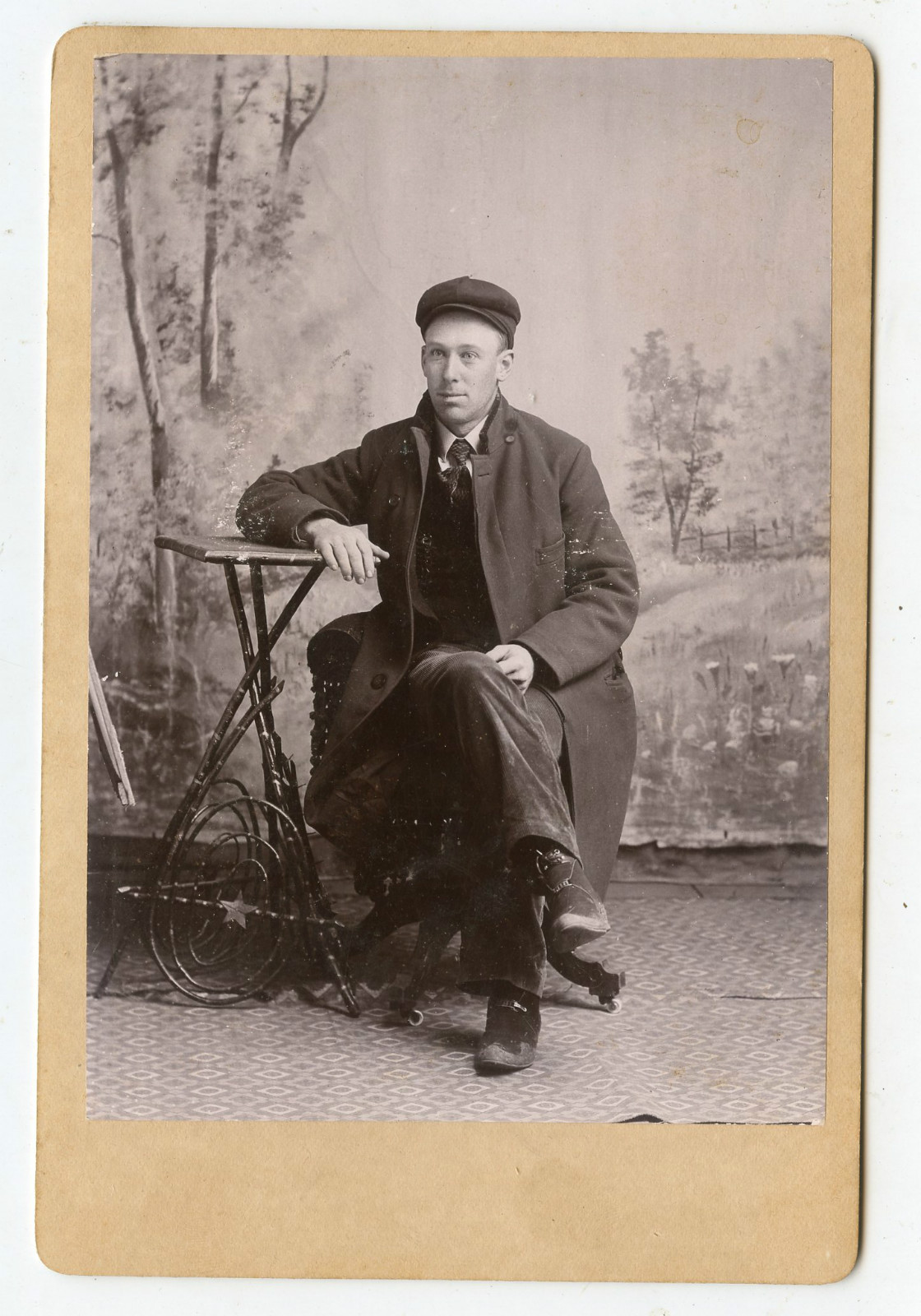 Cabinet Photo - Man Wearing Cap & Long Coat Sitting - Outdoor Backdrop Cabinet Photo - Man Wearing Cap & Long Coat Sitting - Outdoor Backdrop