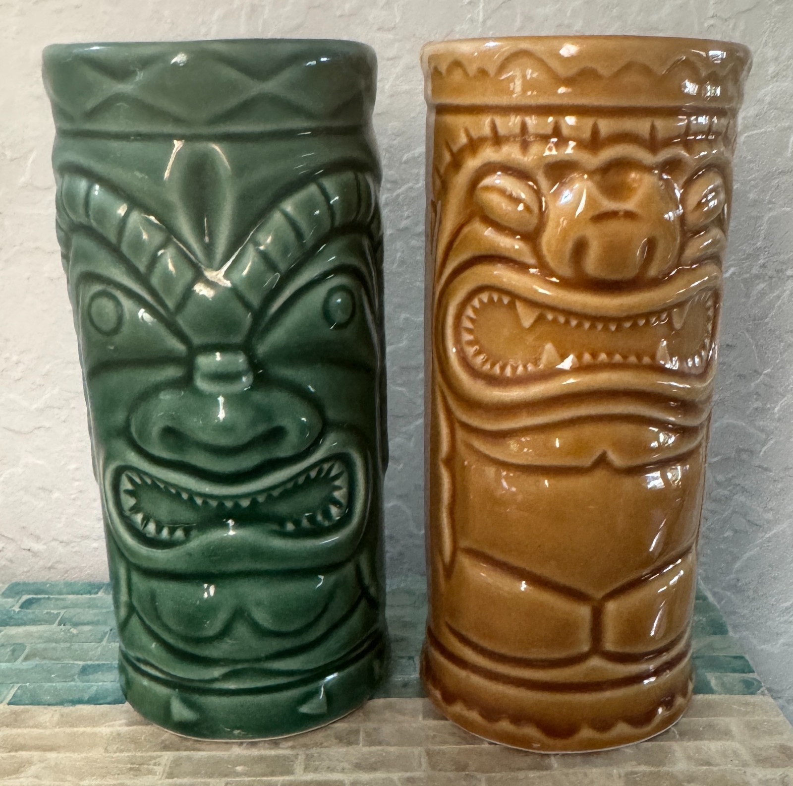 Pair 2001 Accoutrements ceramic Tiki tumblers in green & tan 5 1/2\