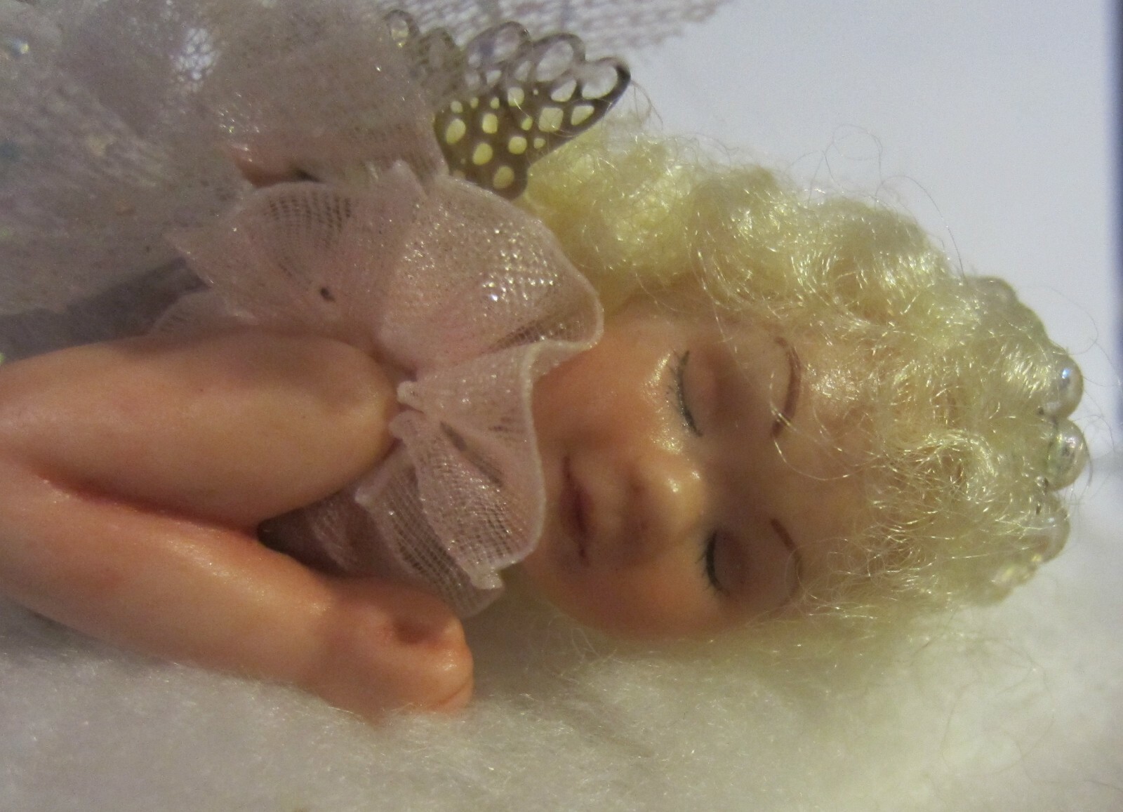 Vintage miniature  hand crafted angel doll laying on a cloud