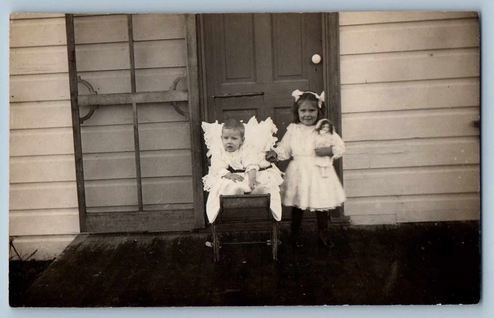 Children Postcard RPPC Photo Baby Girl With Doll Front Of Door c1910\'s Antique