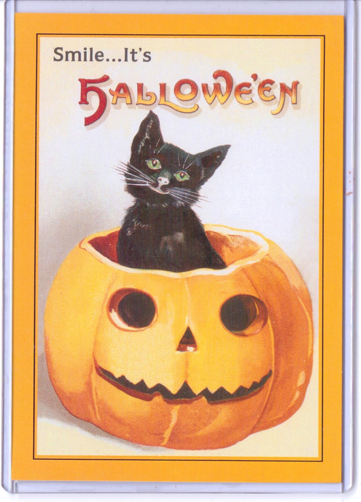 VINTAGE REPRODUCTION SMILE IT'S HALLOWEEN BLACK CAT IN PUMPKIN REPRO POSTCARD 