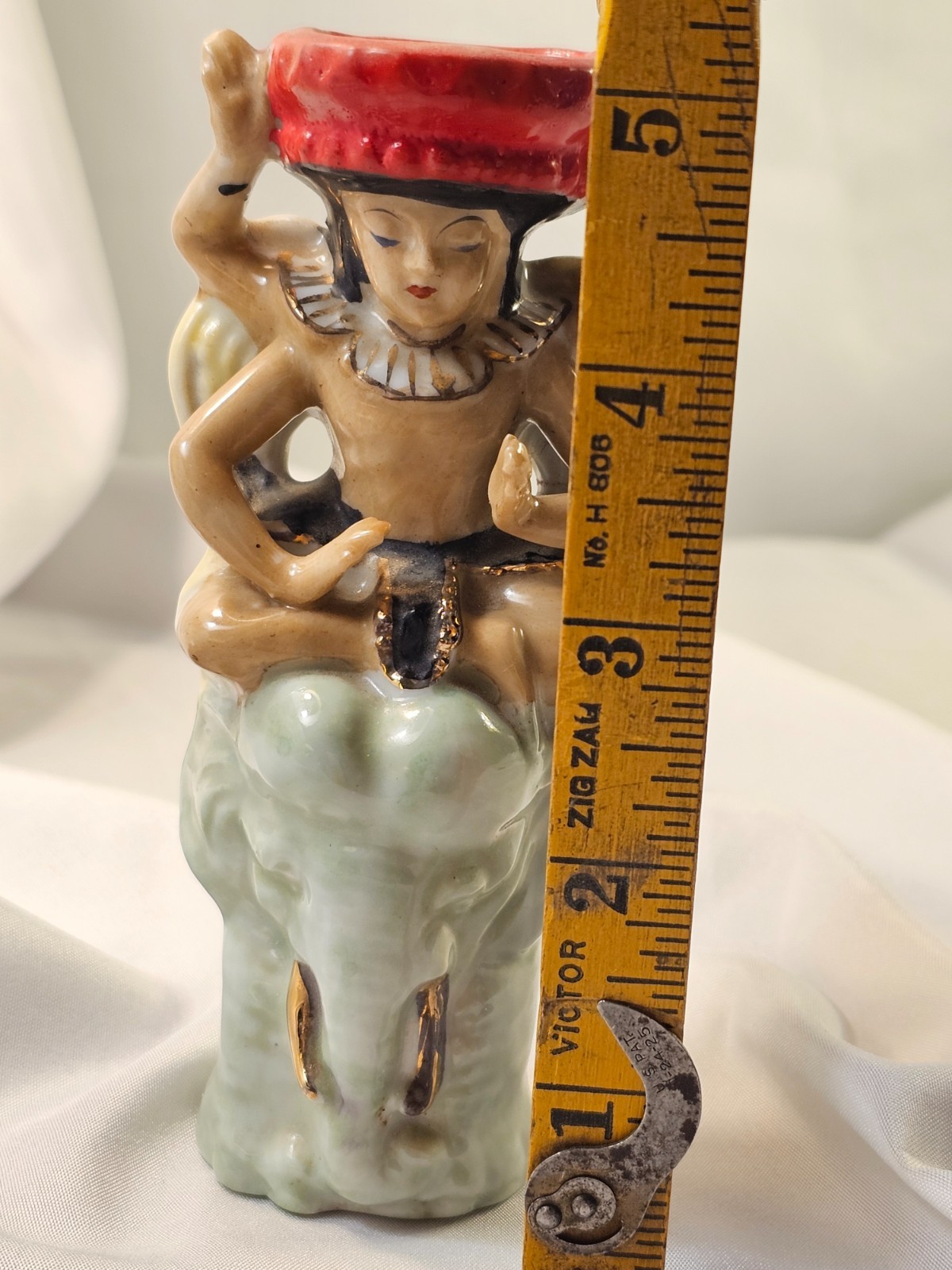 vintage wallpocket hindu indian figurine with four arms sitting on elephant