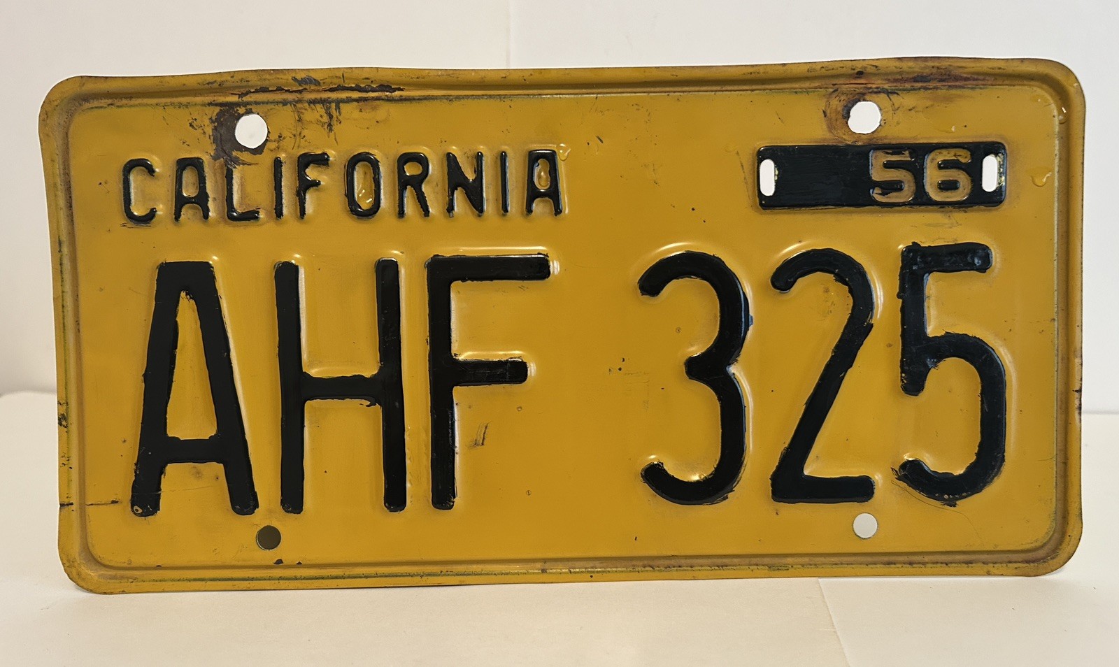 Vintage 1956 California license plate “AHF 325” black & yellow 