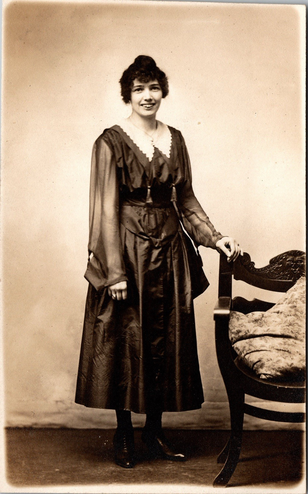 Postcard Real Photo RPPC Young Woman in Black Standing Next to Chair