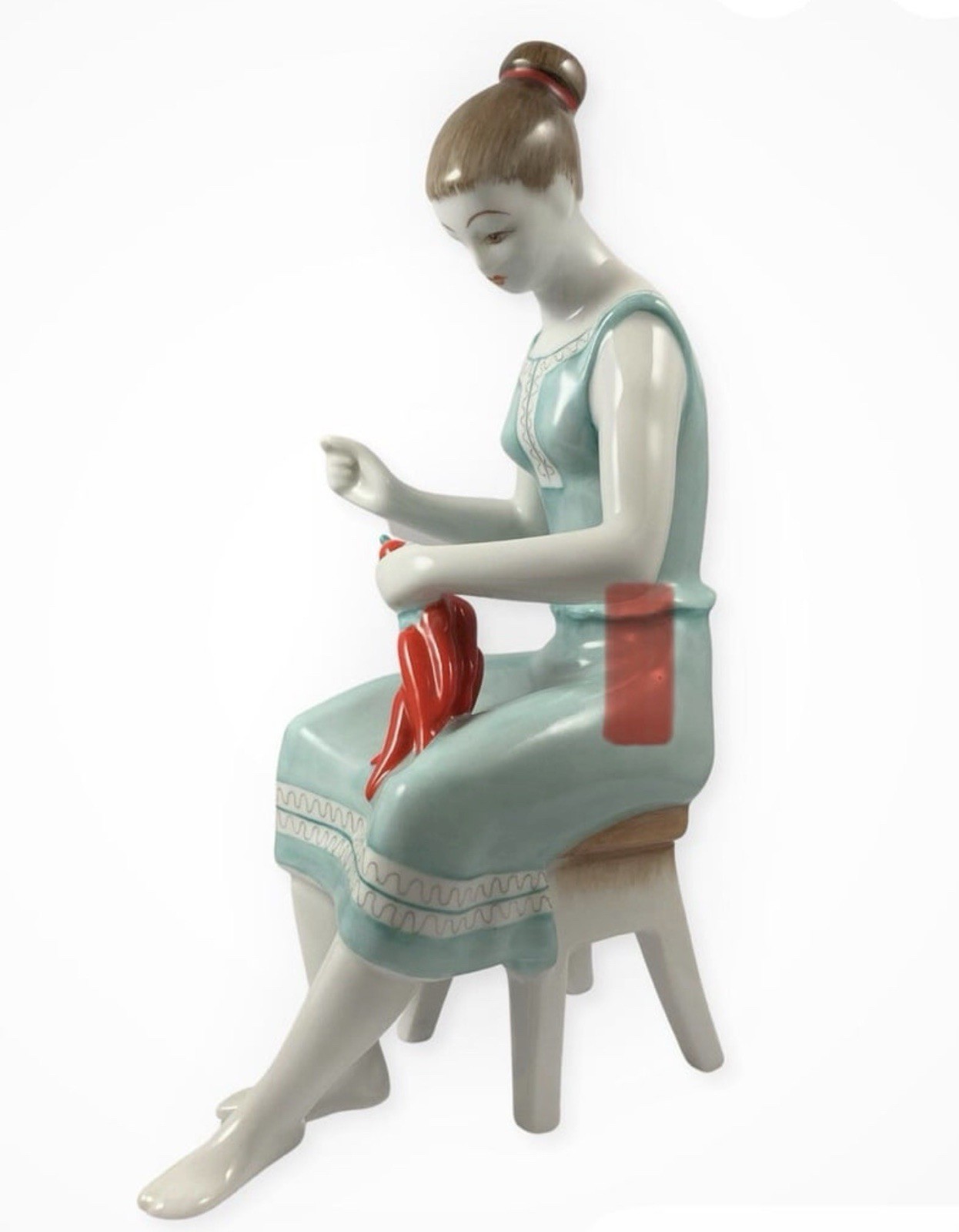 Vintage Hollohaza porcelain a woman sitting on a stool stringing paprika peppers