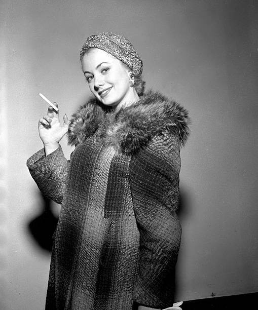 US actress Shirley Jones dressed in a fur trimmed coat with a ciga- Old Photo