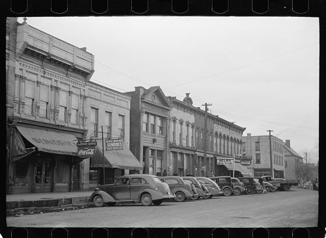 Photo:Main Street Storefronts Cars 1930s Downtown Commercial Street Scene