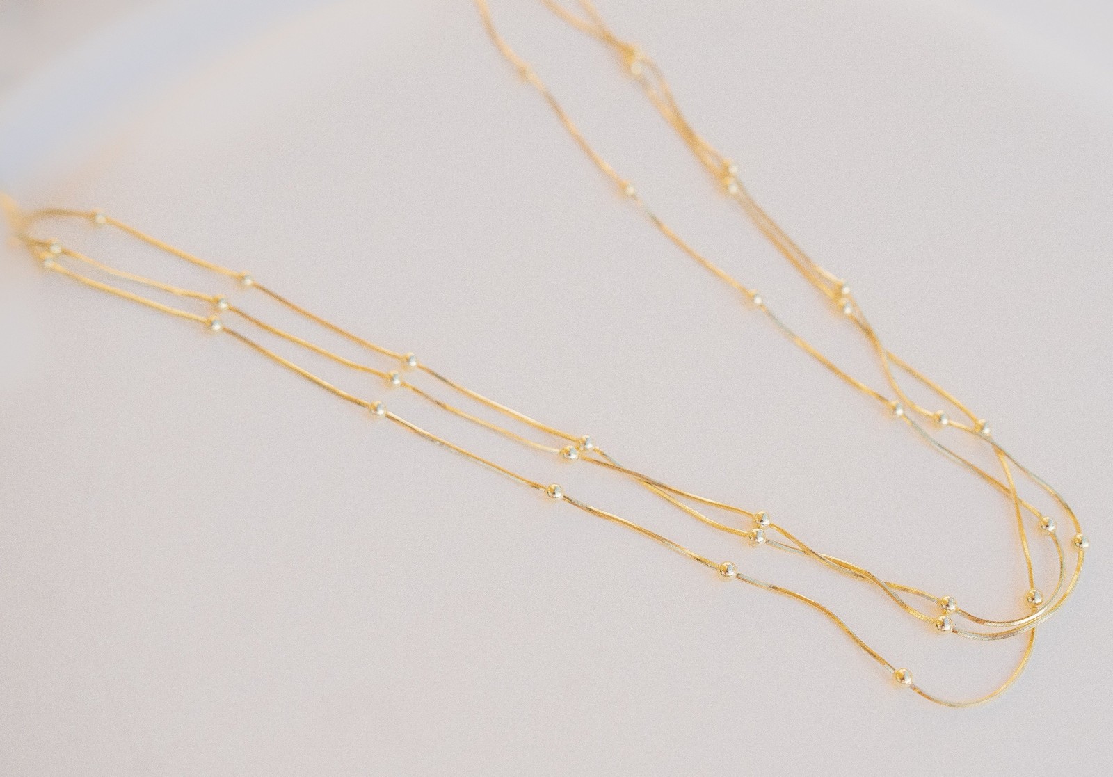Triple Strand Bead Station Necklace Gold