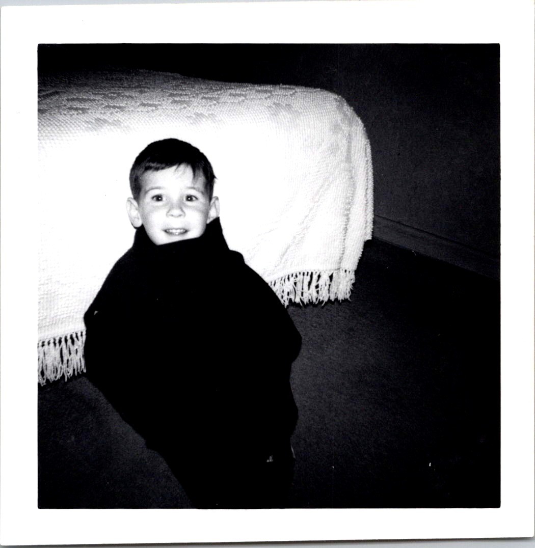 Playful Young Boy Wrapped in Coat, 1965 B&W Snapshot Photo