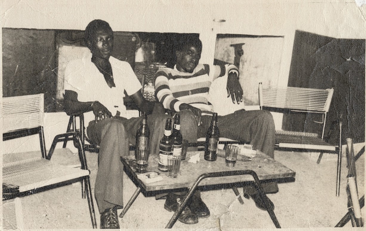 c. 1970's Two Young Men Lounging at Party Photograph by MALICK SIDIBE [Stamped]