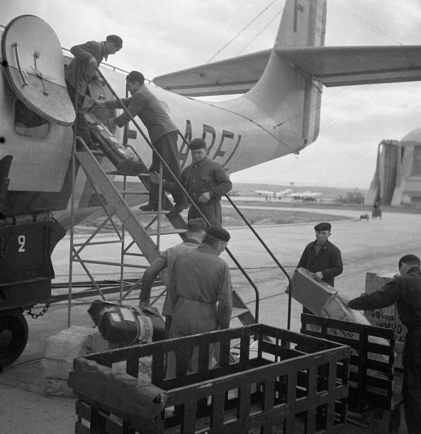 Personnel loading parcels luggage into hold of an aircraft Marigna- Old Photo